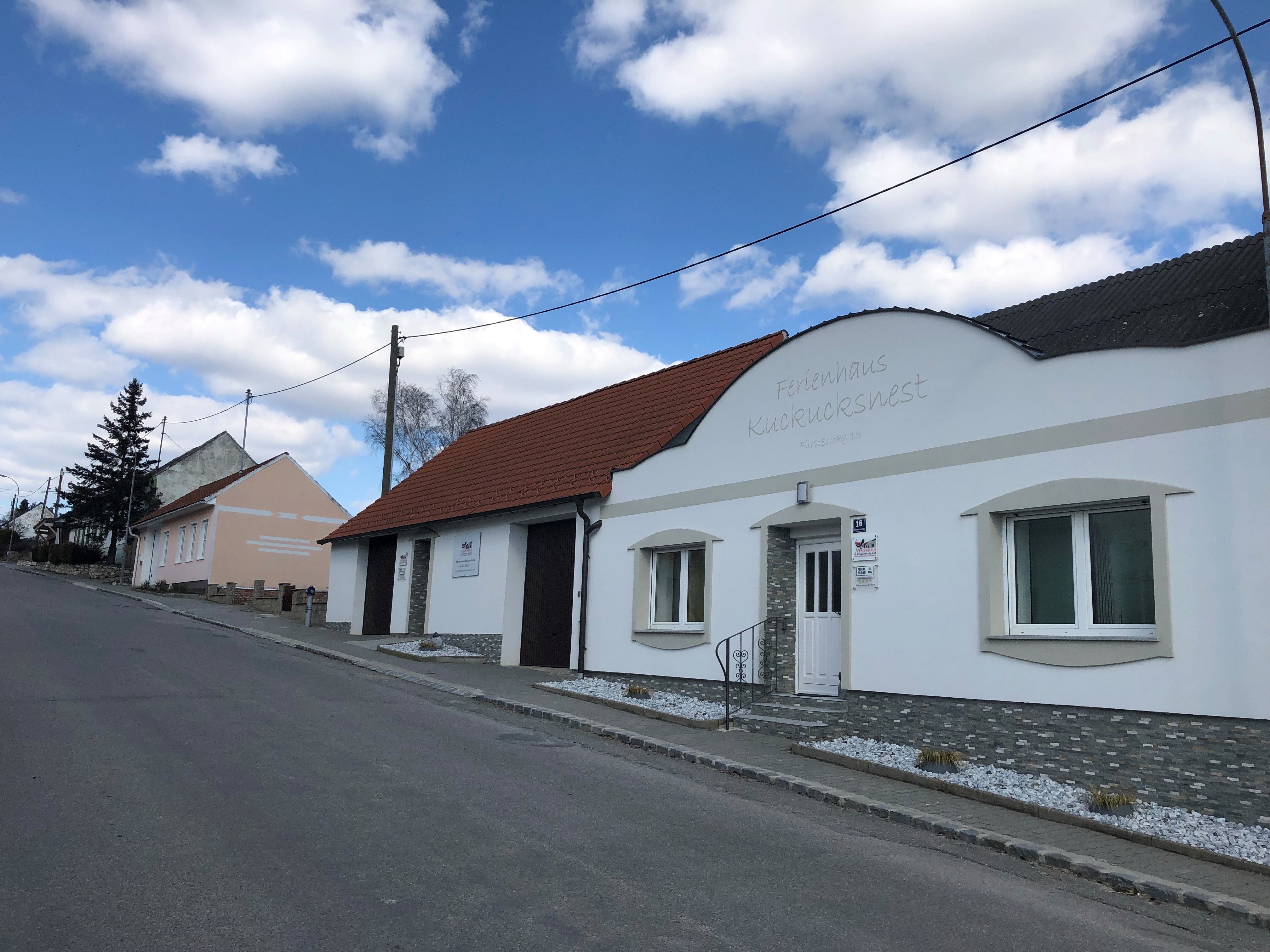 Street with vacation home Kuckucksnest and blue sky.