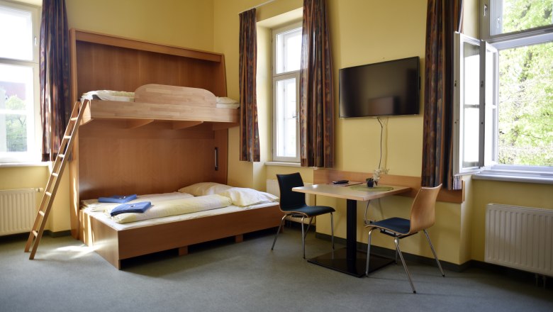 Double room that can be converted into a multi-bed room with a wall bed