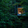 An illuminated tree house in a dense forest at dusk.