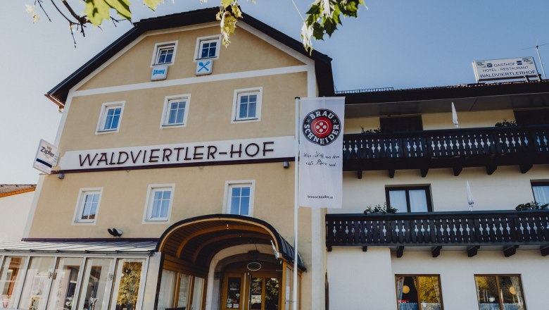 Exterior view of the Waldviertler-Hof with balconies and advertising banner.