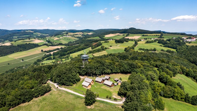 Aerial view of the Celtic village of Schwarzenbach with observation tower in the middle of a green landscape.