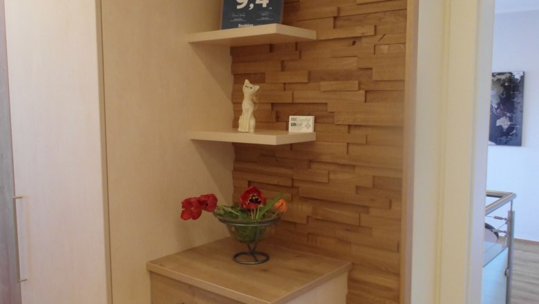 Wooden cupboard with shelves, plants and decorations.