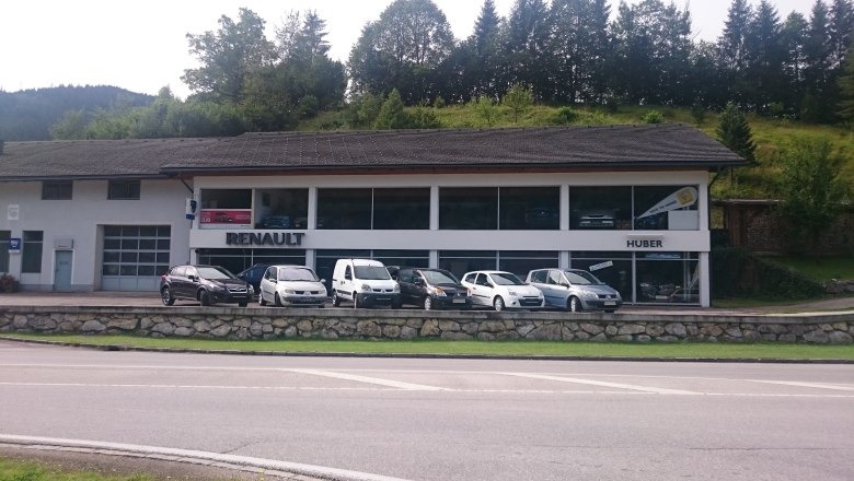 Autohaus Huber with Renault logo and several cars in front of it.