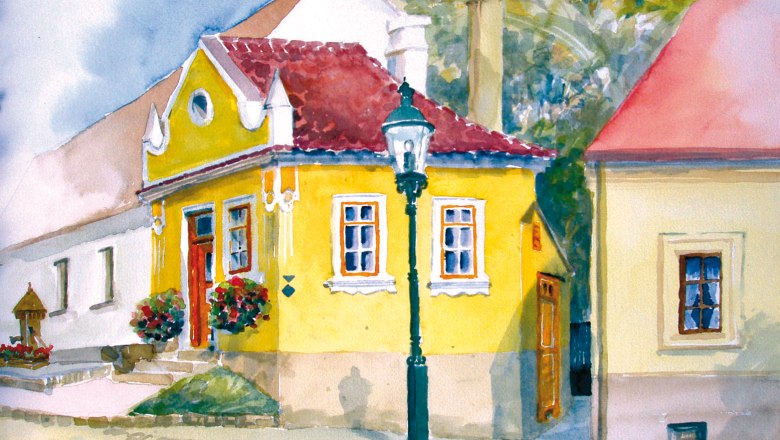 Watercolor of a yellow house with red roof tiles and flowers in front of the door.