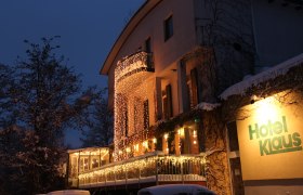 An illuminated hotel building decorated with fairy lights.