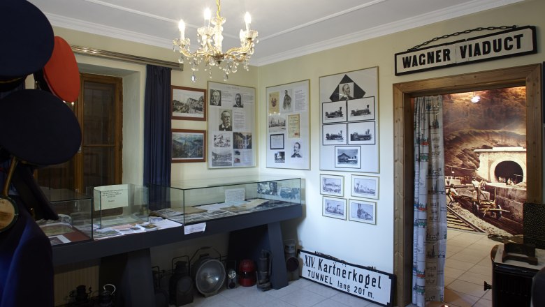 Interior view of the Ghega Museum with exhibits and photos.