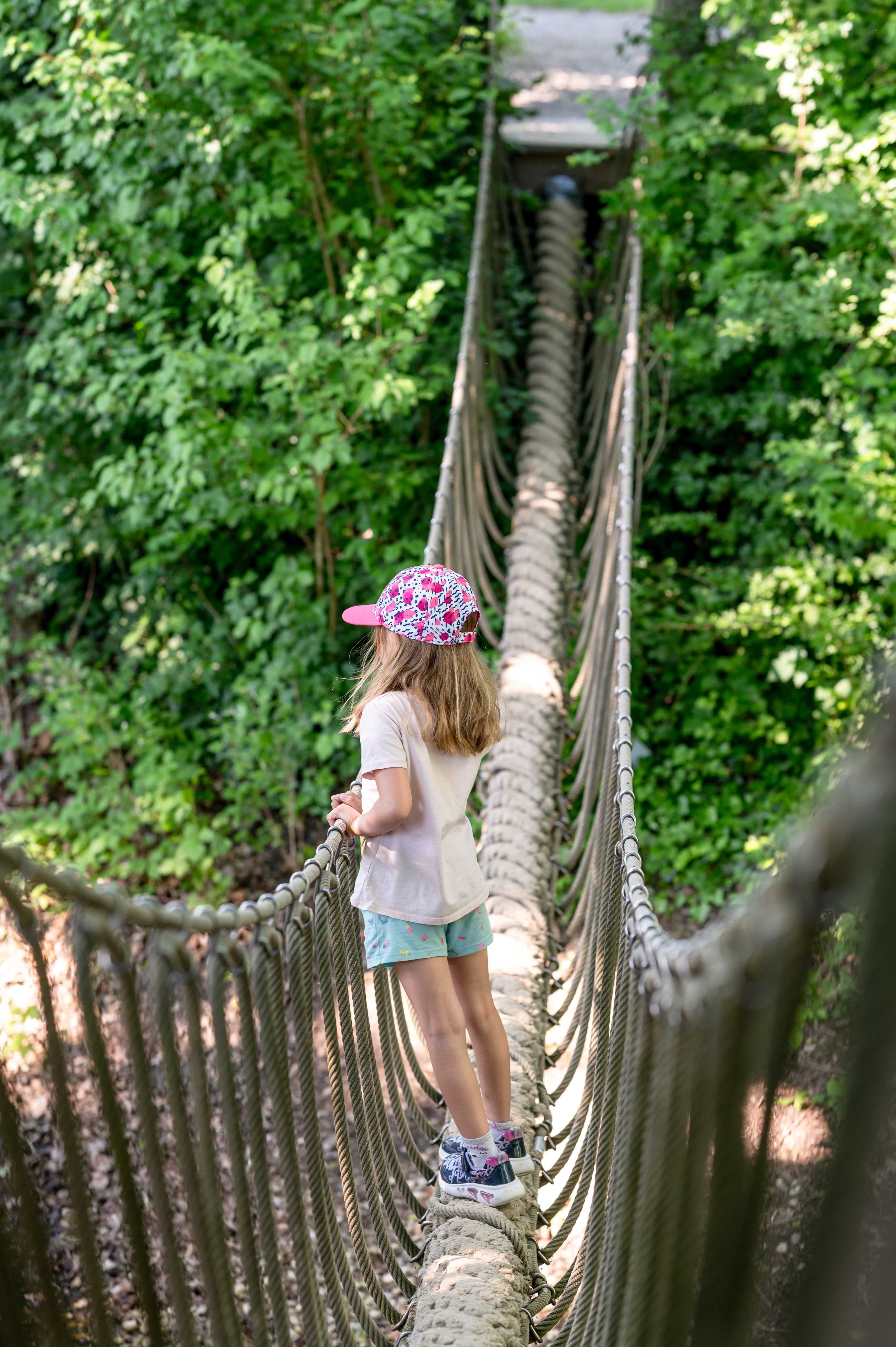 Child on suspension bridge
