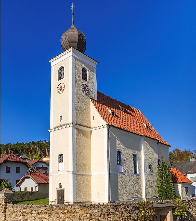 Hollenthon parish church with onion dome and blue sky.