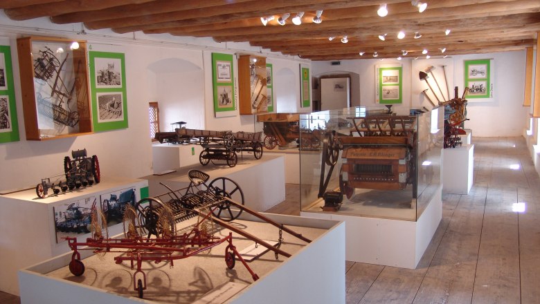 Exhibition of agricultural machinery models in a museum.