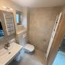 Modern bathroom with washbasin, WC and towel radiator.