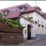 Traditional house with red tiled roof and flower boxes on the windows.