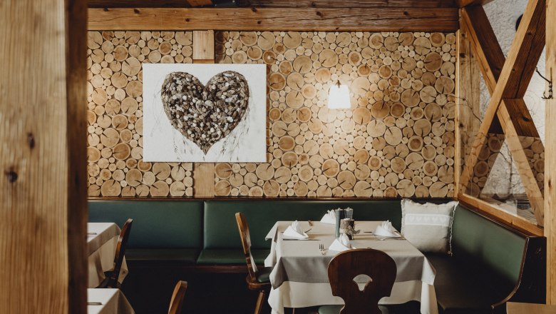 Cozy pub with wooden wall and heart picture.