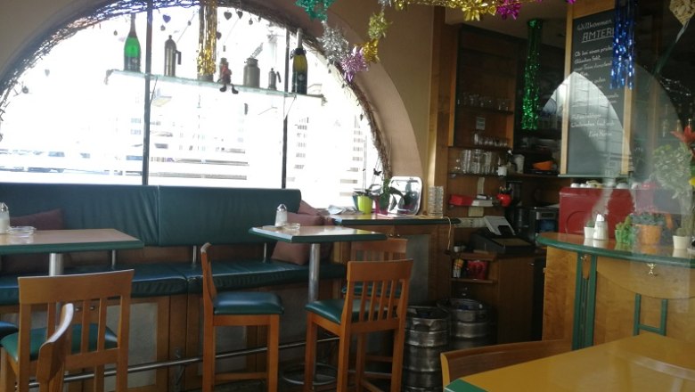 Interior view of a cozy caf&eacute; with decorations and seating.