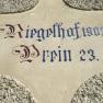 Inscription 'Riegelhof 1903 Prein 23' on a wall.