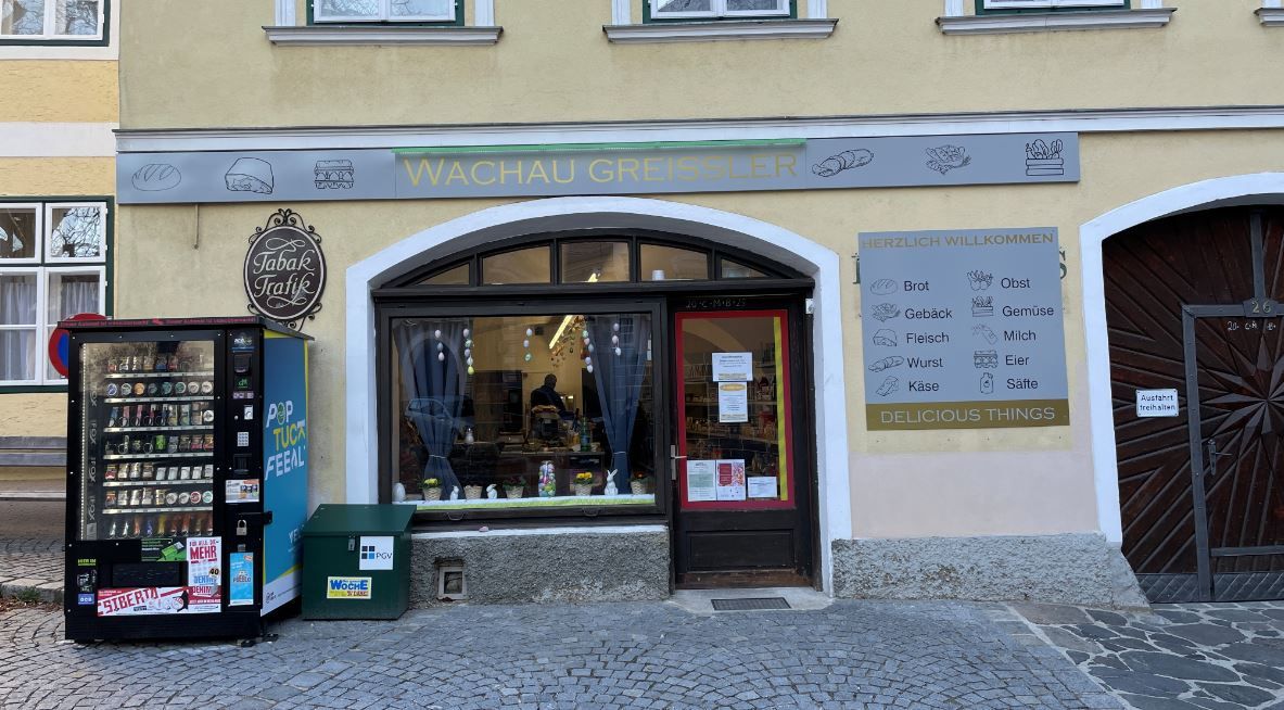 Store entrance with a vending machine in front of it