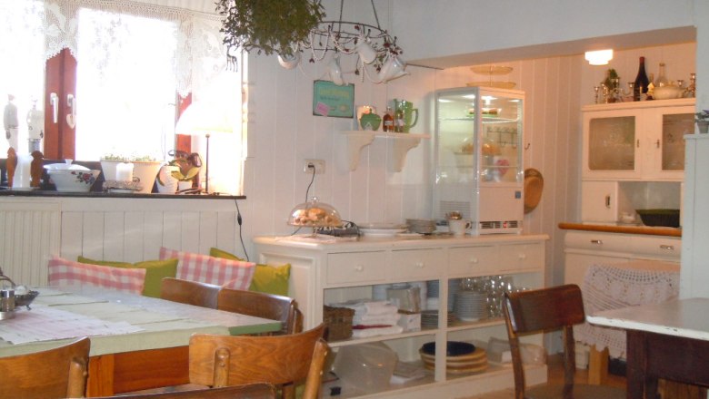 Cozy kitchen with breakfast buffet, wooden furniture and decorations.