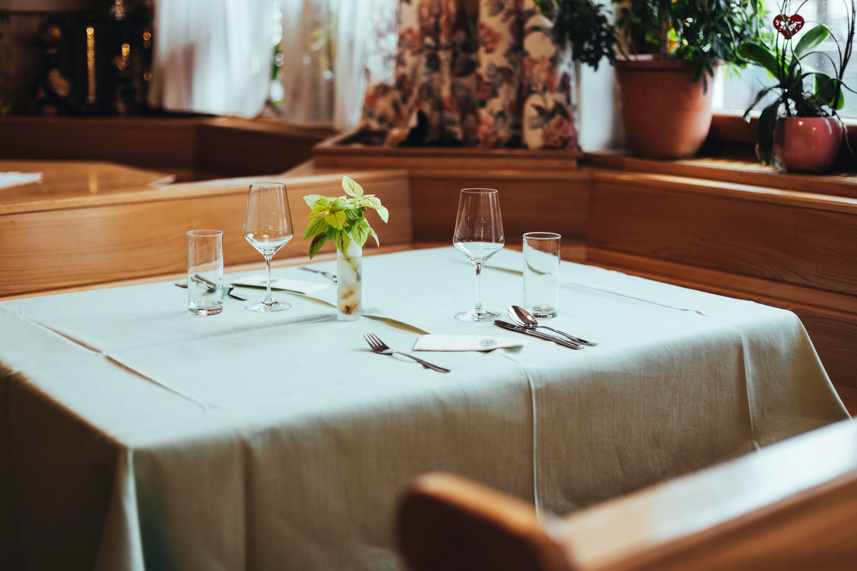 Elegant table in a restaurant set with glasses and cutlery.
