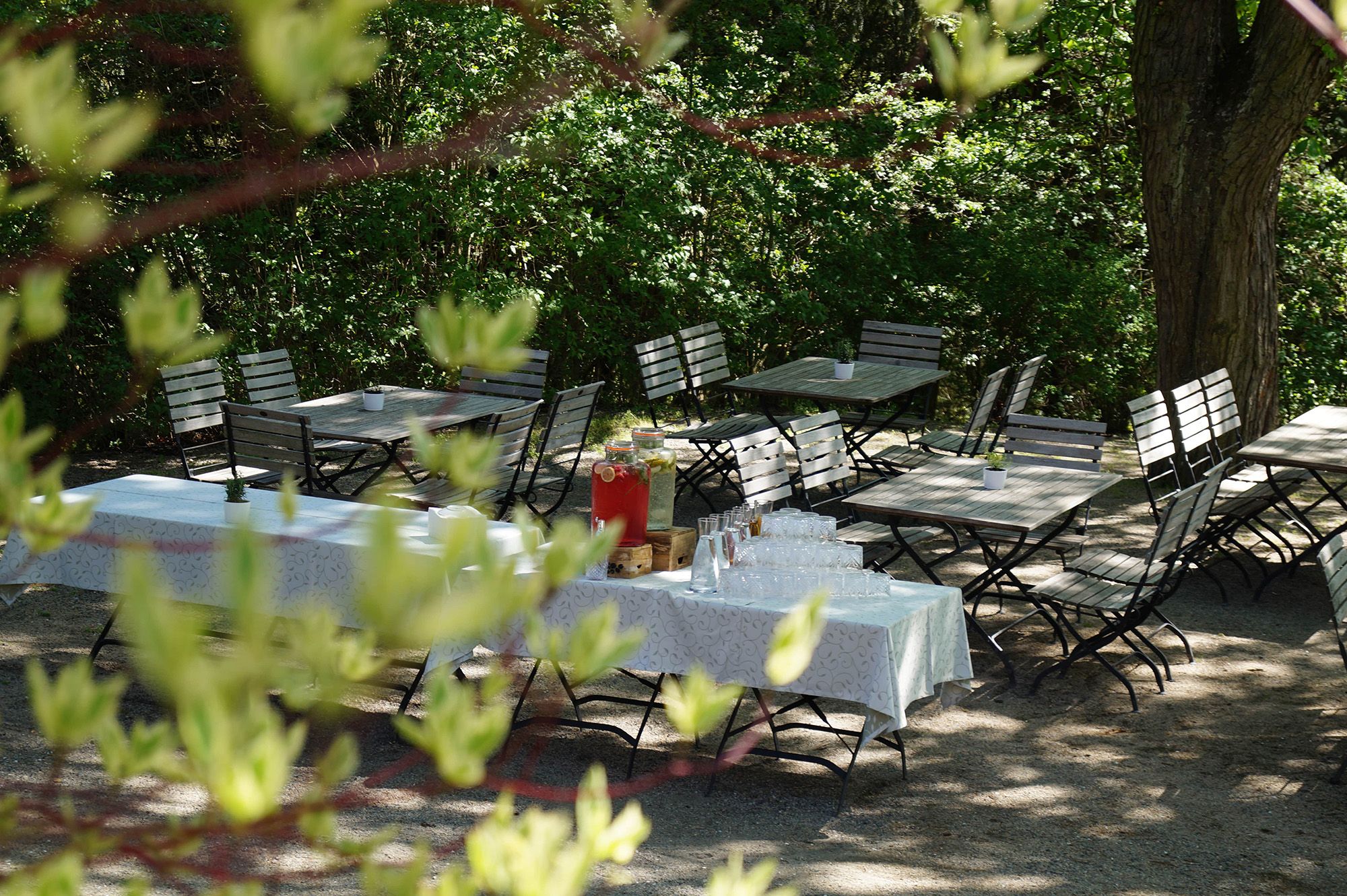 Elegant function room with a long, festively laid table and white chairs.