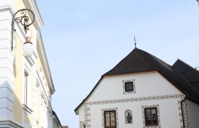 Historic street lamp on a building in an old town.