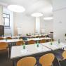 Conference room in the Hotel Altes Kloster with tables, chairs and flipcharts.