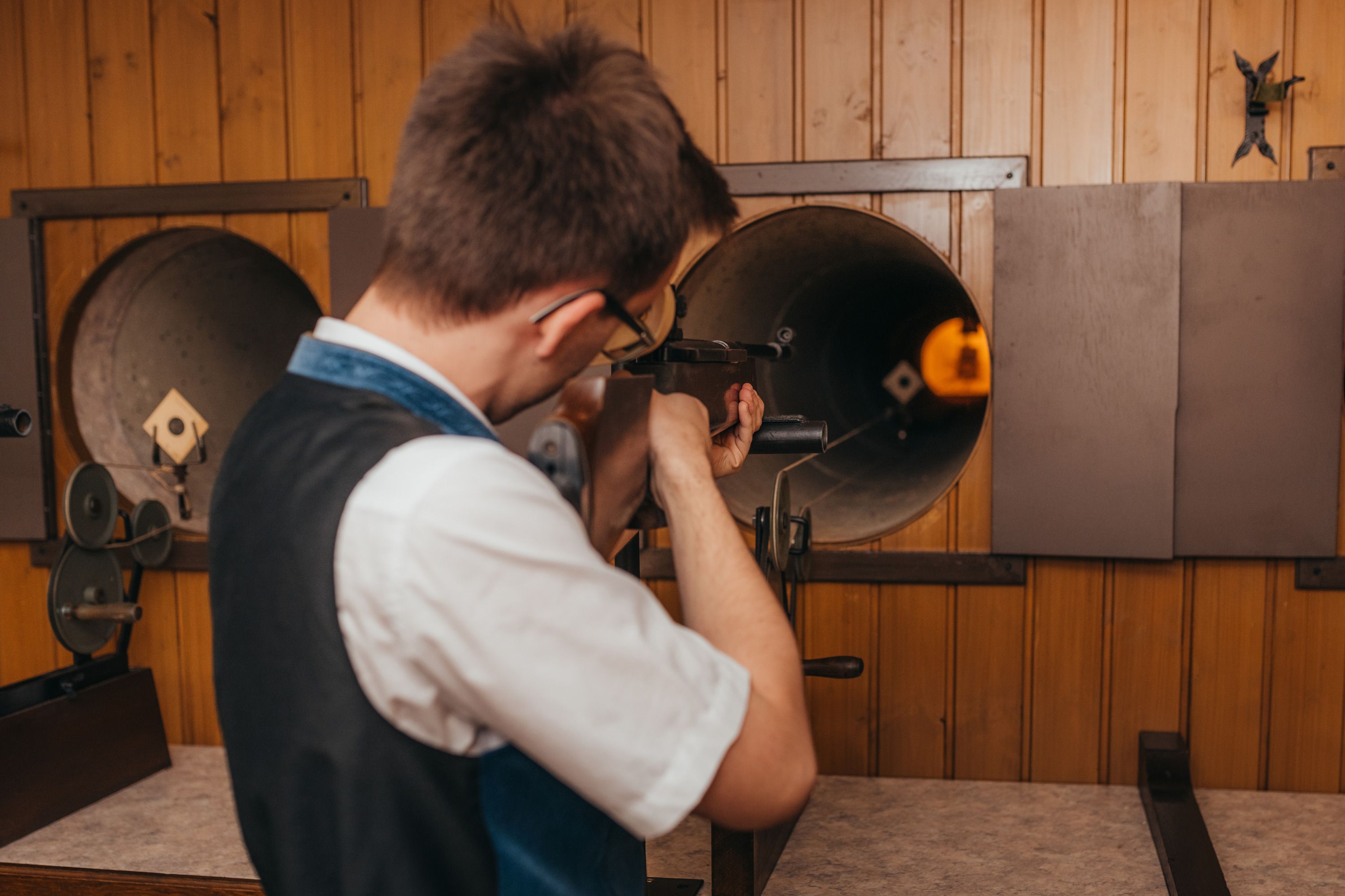 Person aims a rifle at a shooting range.