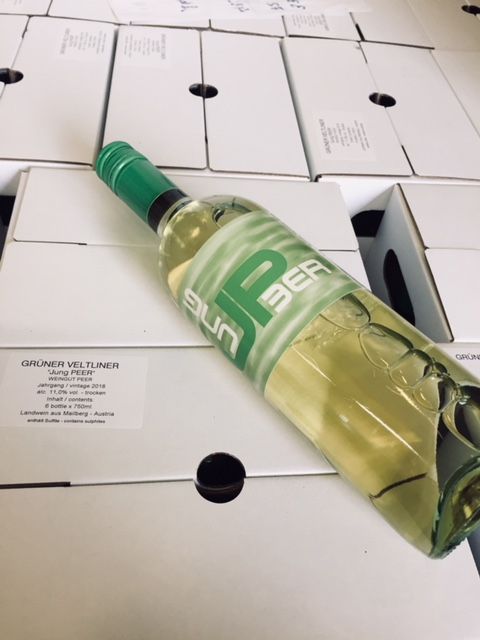 Grüne Veltliner wine bottle on cardboard.
