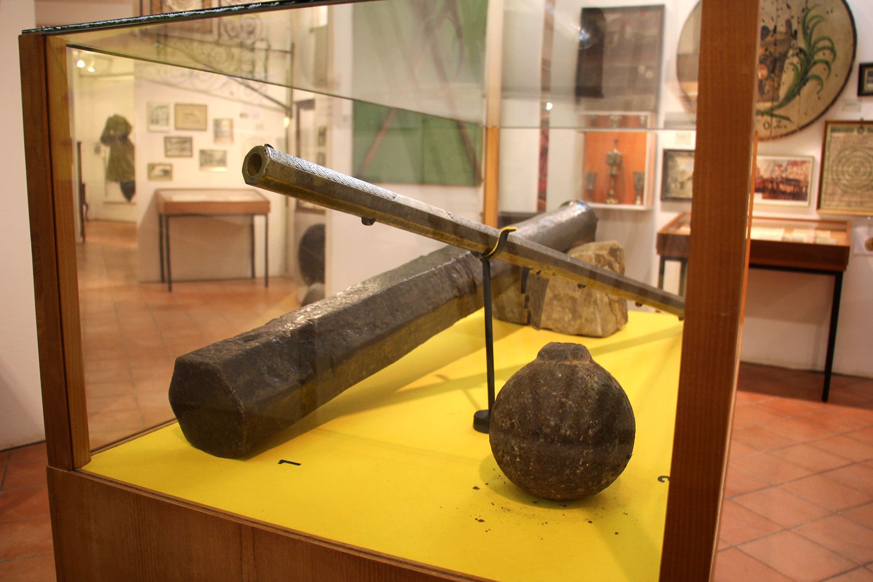 Exhibit in the Stockerau District Museum with old weapons and artifacts.