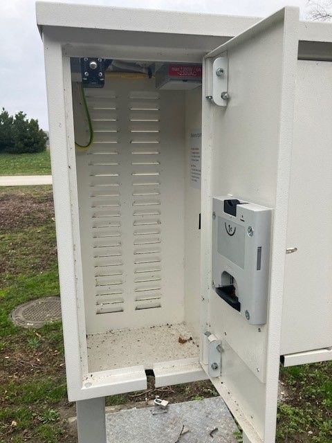 Open e-bike charging stations outdoors with empty interior.