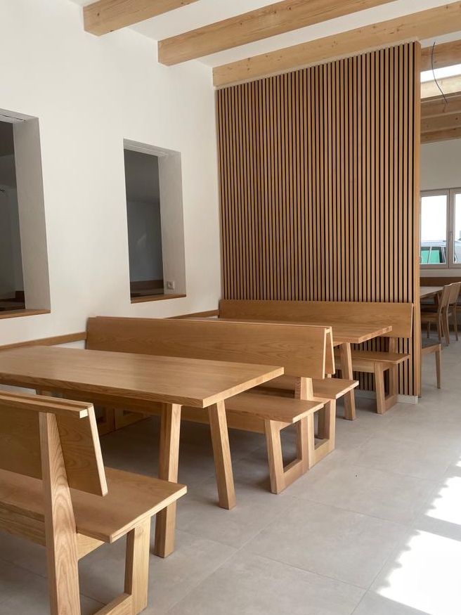 Interior view of a wine tavern with wooden furniture and modern elements.