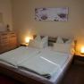 Comfortable bedroom with double bed, bedside lamps and chest of drawers.