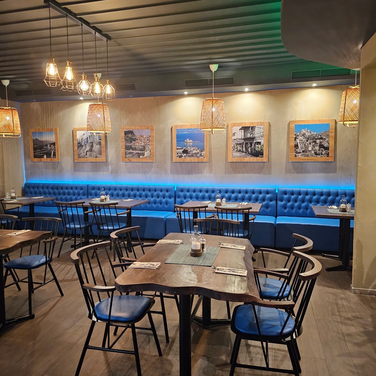 Blue armchairs and laid tables inside the restaurant