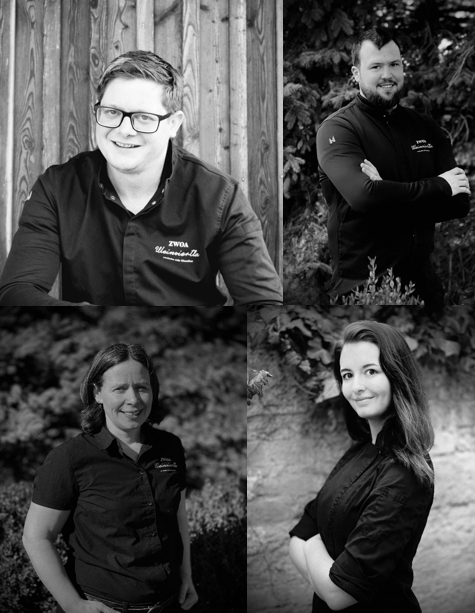 Four people in black and white portraits, smiling and posing in work clothes.