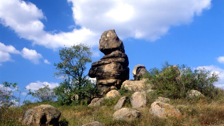 Kogelstein rock formation under a blue sky with clouds.