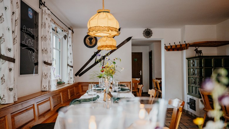Cozy dining room with wooden furniture, table decorations and rustic details.