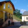 Yellow building with stairs and a small church next to it.