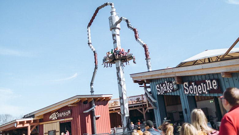 People ride on the Milkshaker ride in the Eis-Greissler amusement park.