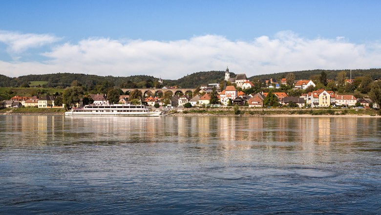 Panorama of the municipality of Emmersdorf an der Donau with a ship on the river.