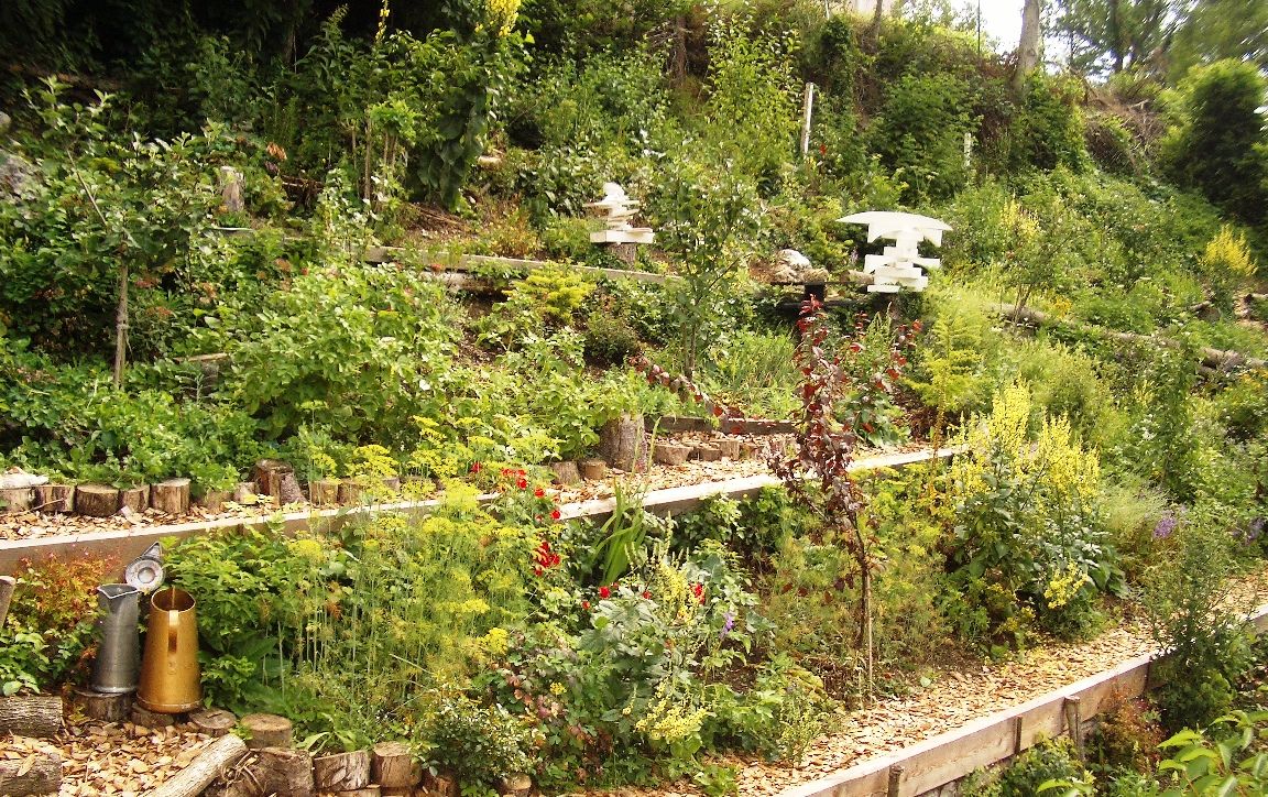Terraced garden with lush vegetation and decorative elements.