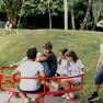 Children playing on an outdoor carousel.