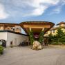 Entrance to the Naturhotel Molzbachhof with wood paneling and plants.