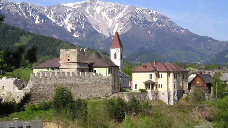 Puchberg castle ruins with snow-covered mountain in the background.