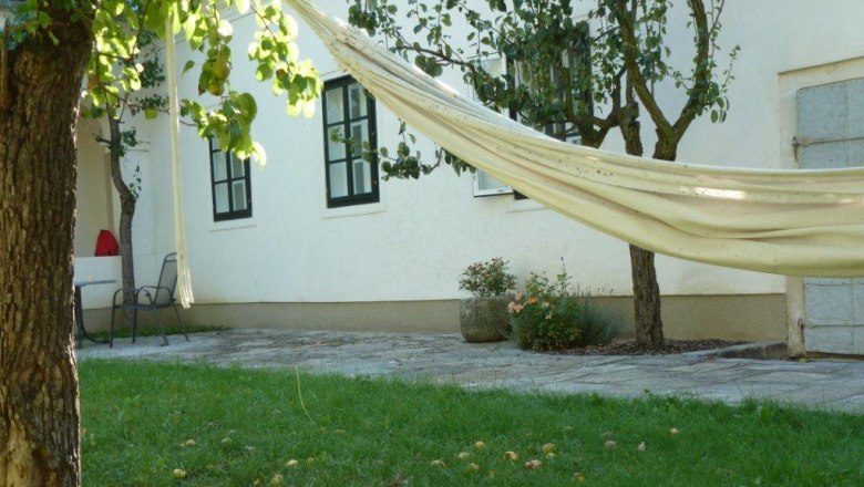 Inner courtyard with hammock, trees and lawn.
