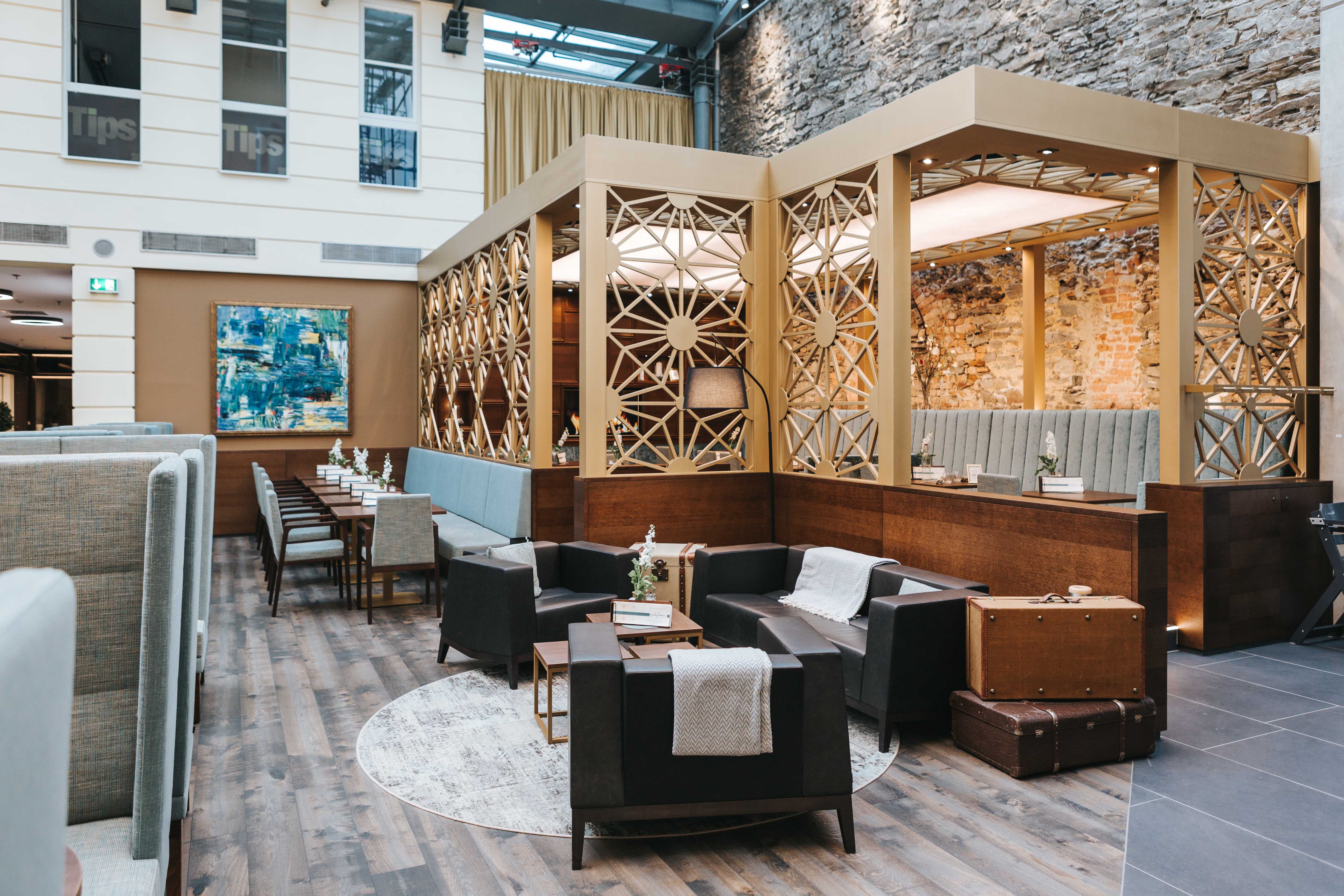 Interior view of a stylish café with modern furniture and decorative walls.