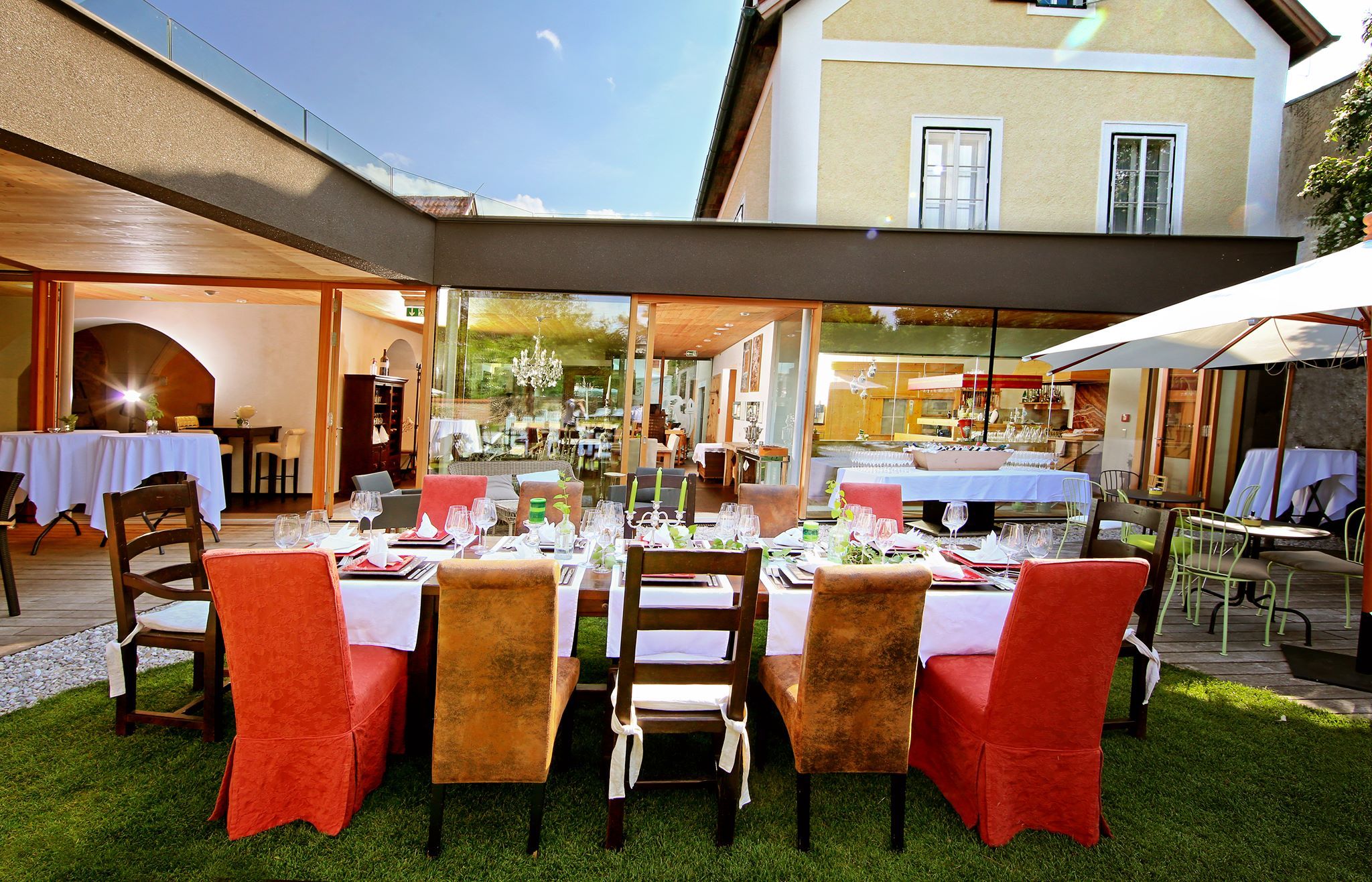 Elegant restaurant with an outdoor table surrounded by modern buildings.