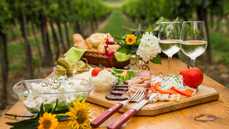 Heurigen snack on a wooden table in the vineyard.