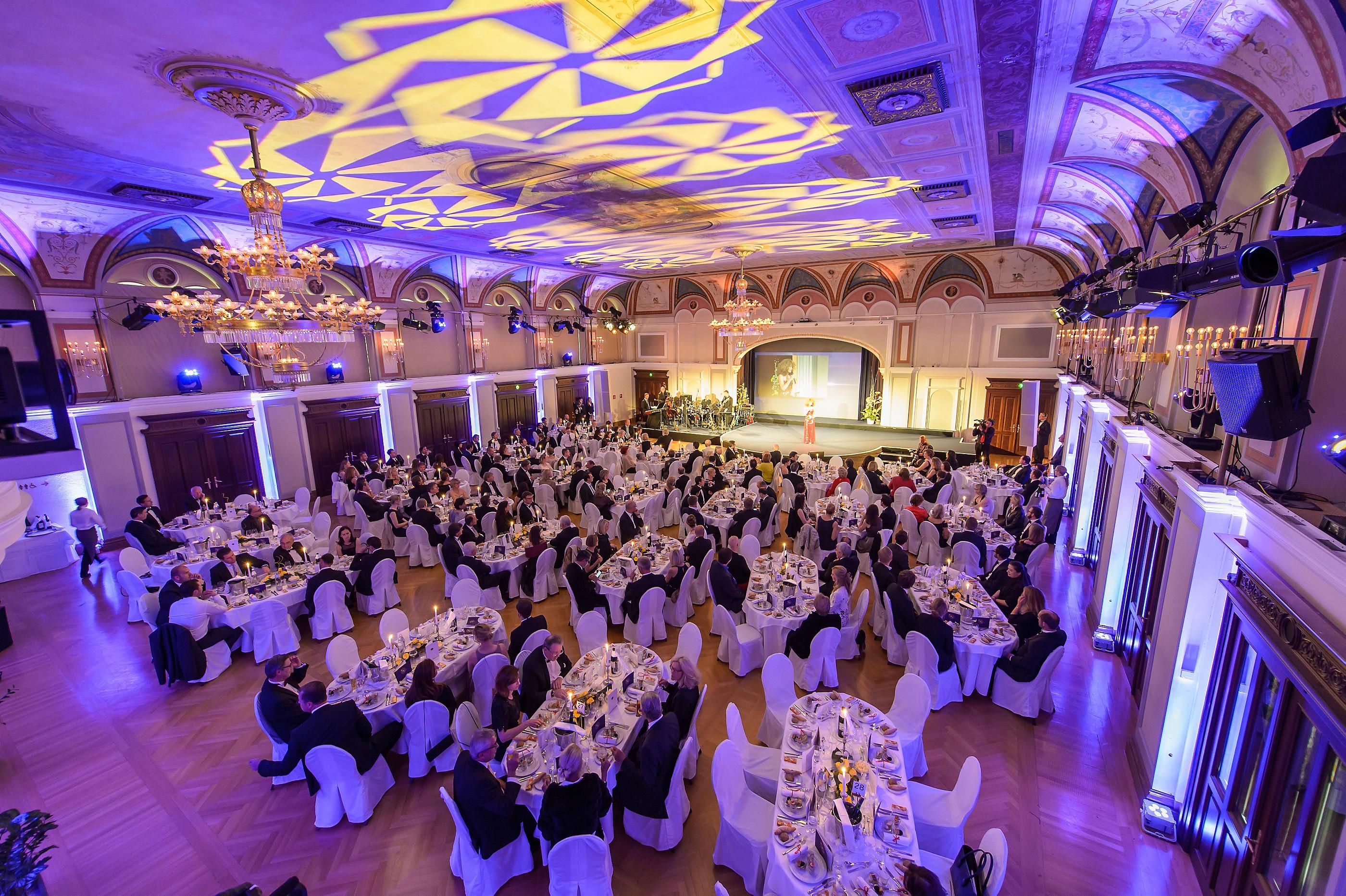 Elegant ballroom in the Congress Center Baden with laid tables and guests at an event.