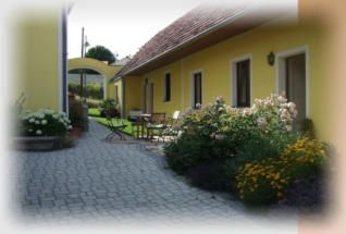 Yellow house with garden and paved path.