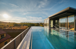 Yellow country estate with red roofs and well-tended garden.