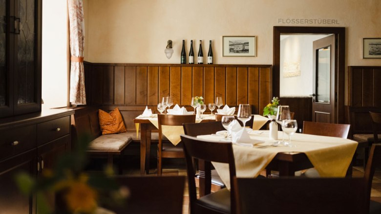 Cozy restaurant with wooden furniture and laid tables.