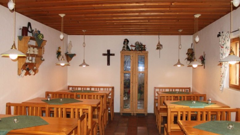 Interior view of a rustic wine bar with wooden furniture and decorations.